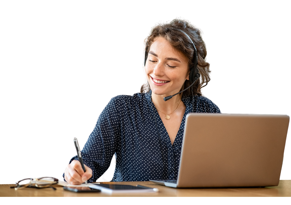 Woman at a desk with a laptop, pen and audio headset
